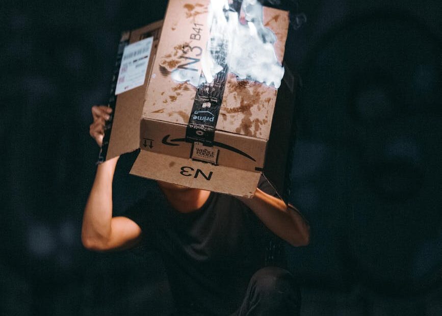 man raising cardboard box