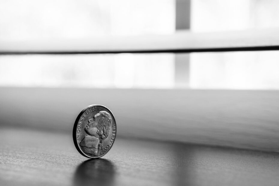 monochrome photography of round silver coin