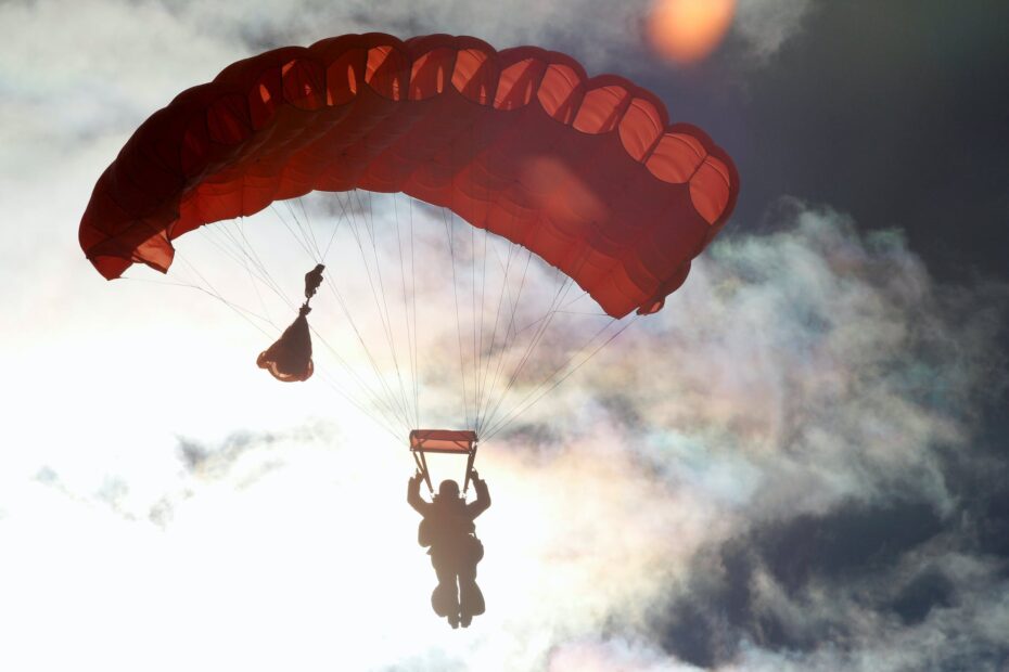 person riding on red parachute