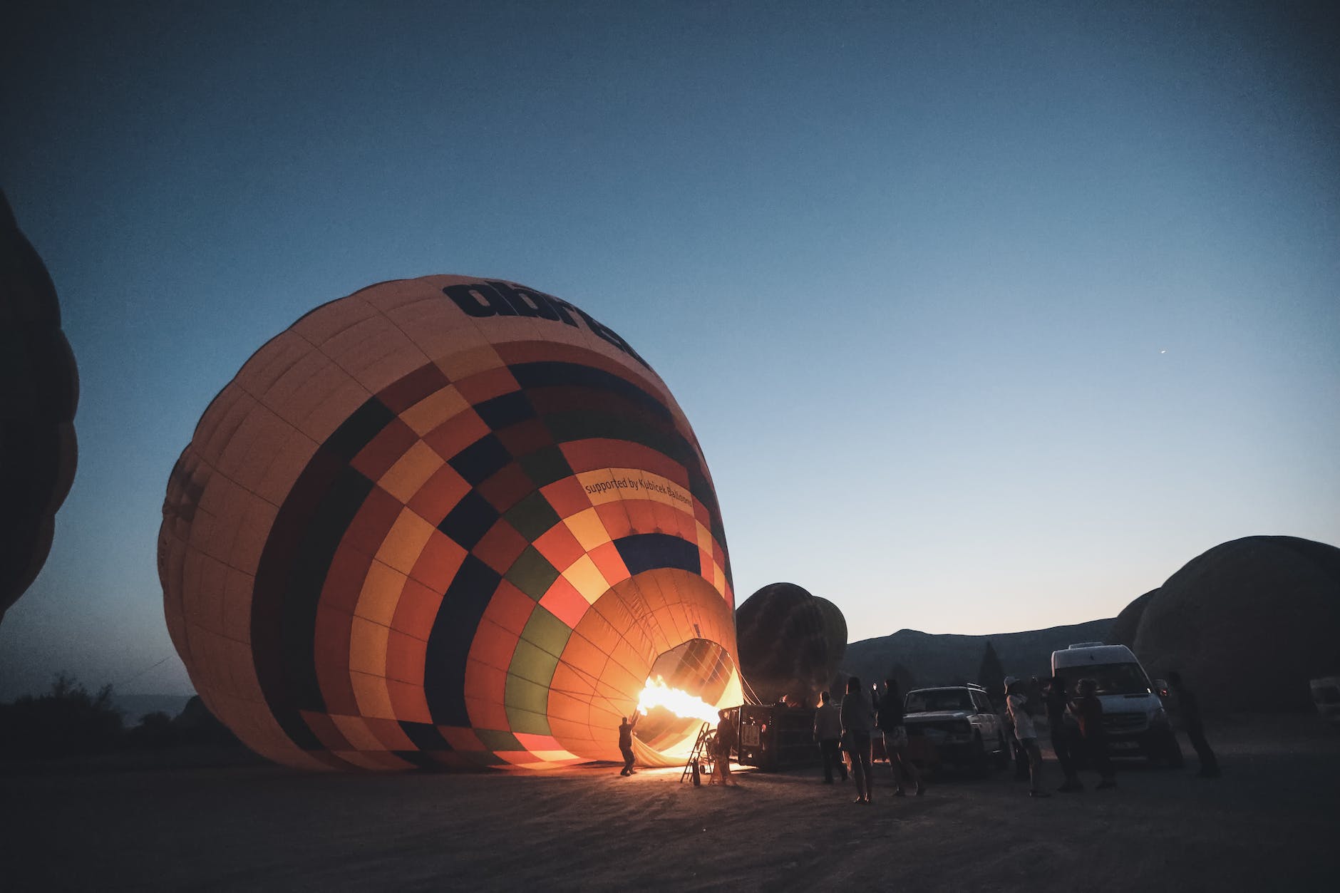 people inflating a hot air balloon