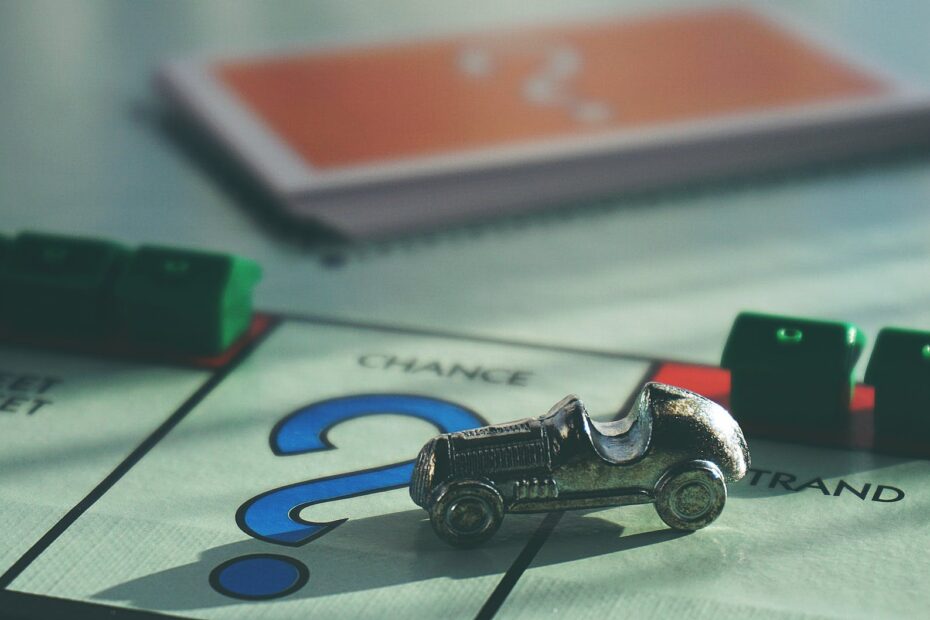 miniature toy car on top of board game
