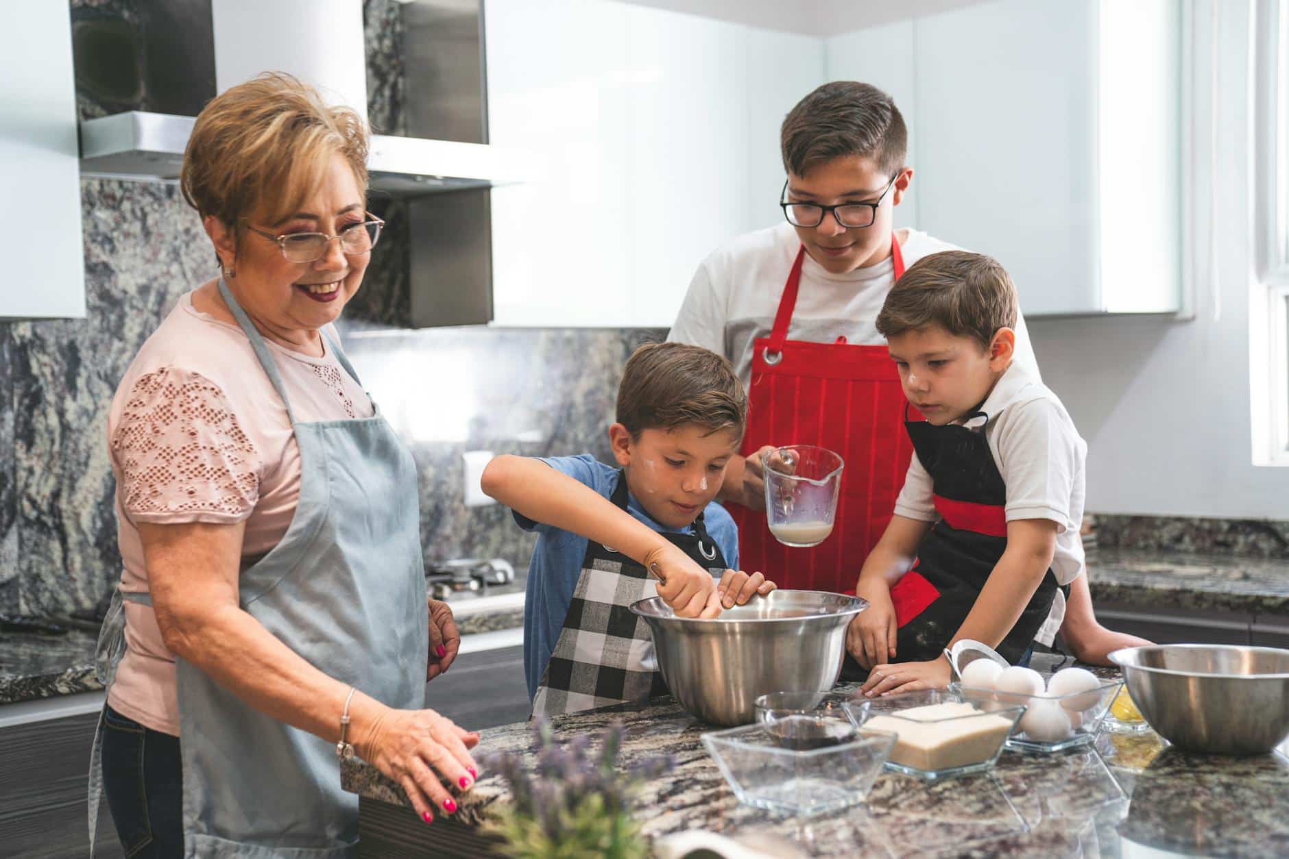 a woman baking in a kitchen with her grandchildren