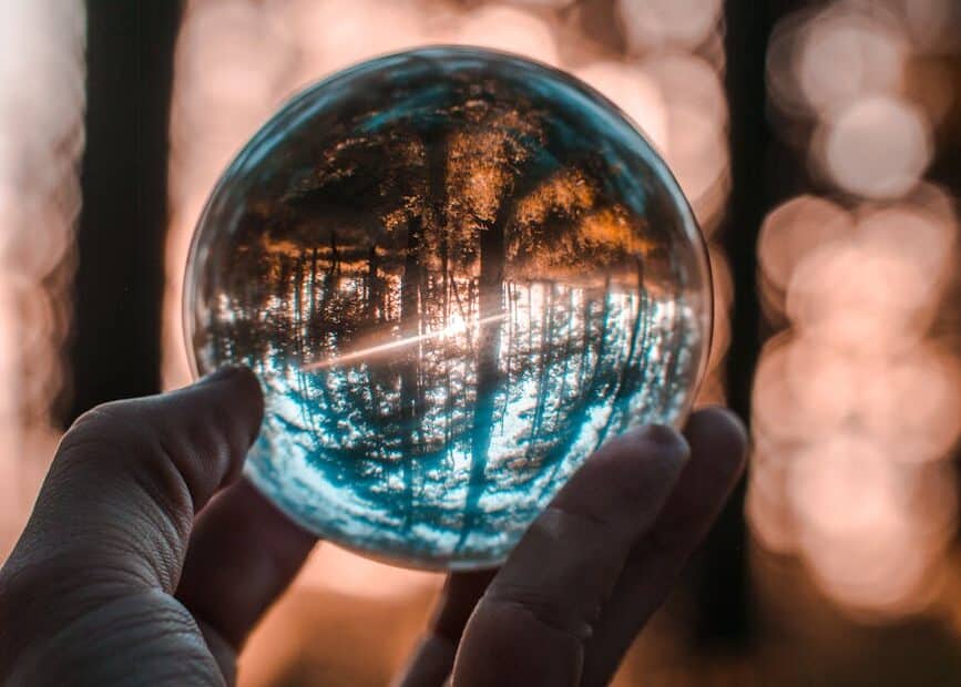 close up photo of person holding crystal ball