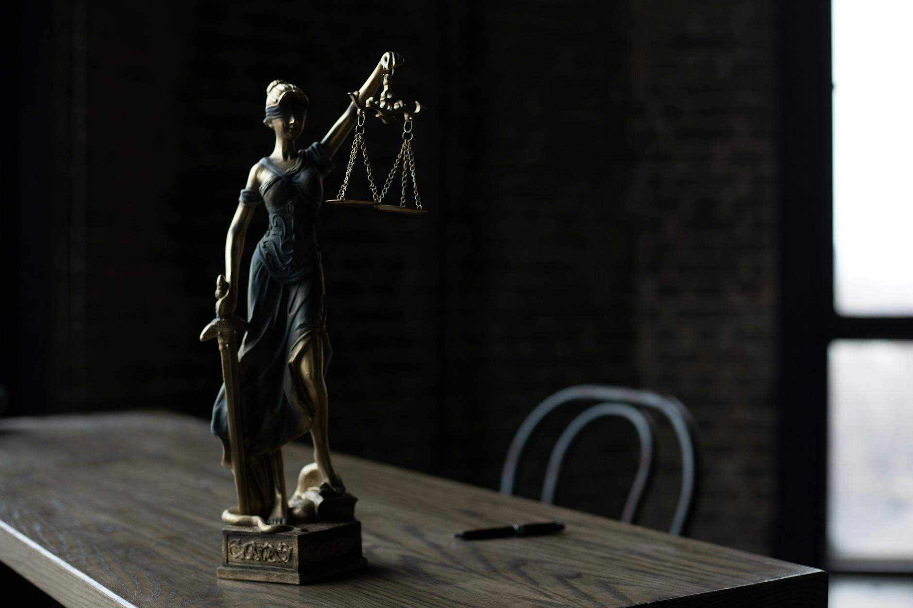 a figurine of the lady justice on a table
