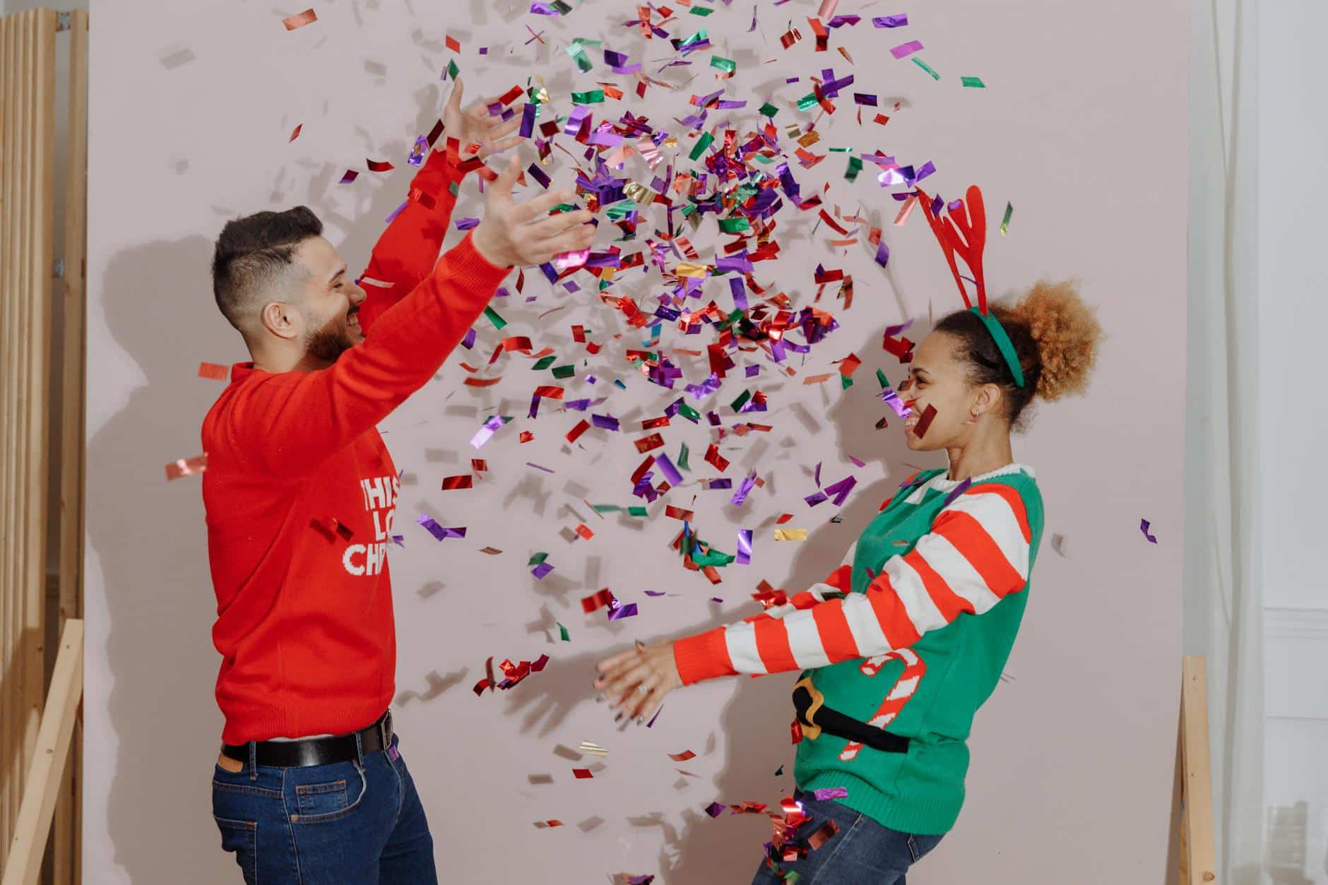 a couple throwing colorful confetti