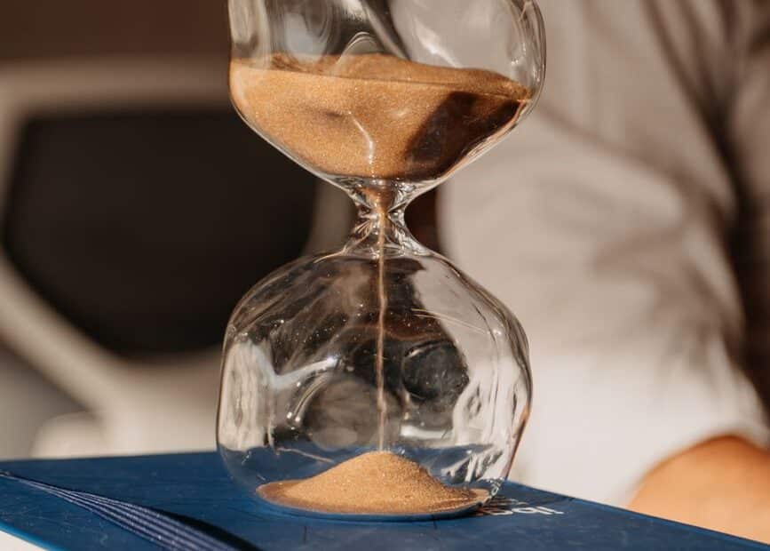 hourglass on books in an office setting