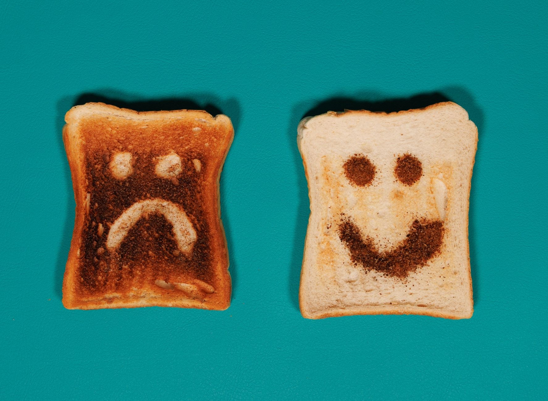 comparison of toasts with happy and sad faces