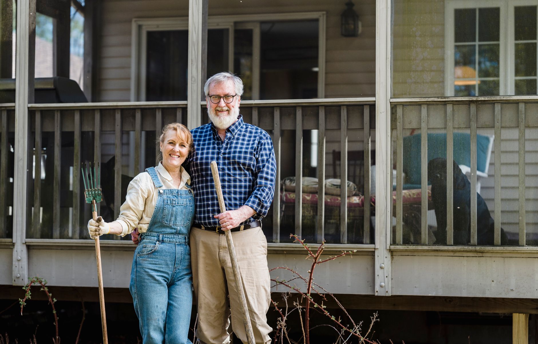 elderly couple standing close together